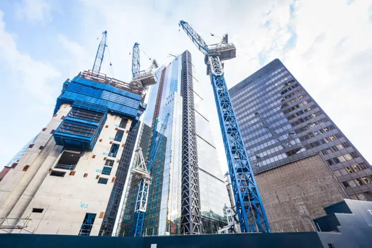 Modern building construction with multiple cranes