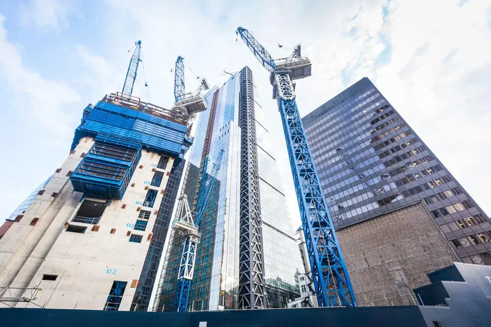 Modern building construction with multiple cranes